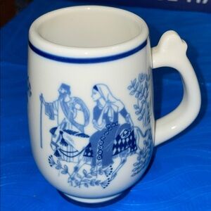 Blue & white porcelain mug from Norway with graphics on back & design on front.